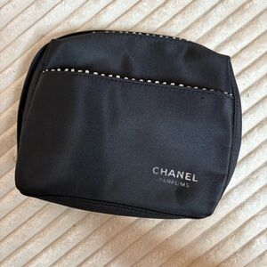 Black Chanel cosmetics bag with silver ribbon design
